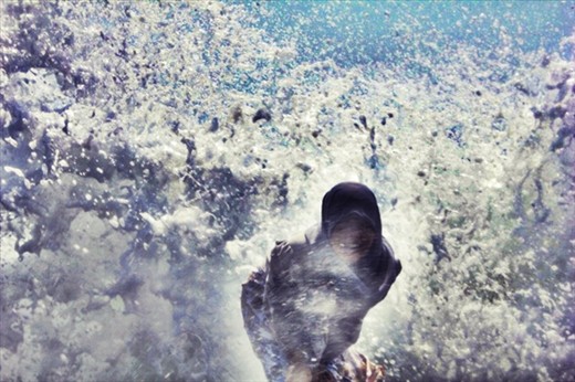 I was enjoying this moment.  I took this picture at Tana Lot Beach Bali using a tripod and timer.  Waiting a view minutes to get this moment.  Standing at the Beach and waiting the wave for getting the best capture.  After it I laugh over load and feel satisfied although everyone look so curios.