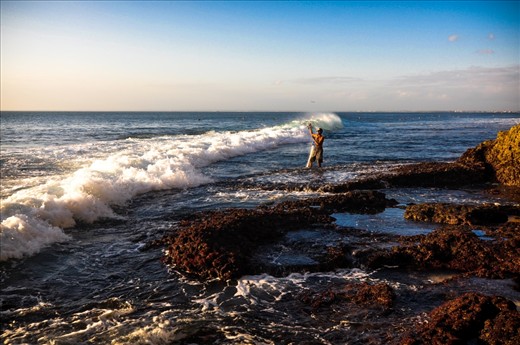 Near dreambeach was a local fisherman that was standing on a very sharp rocks, and the waves was so strong that one wave almost got me and my camera, that is why I admire this local fisherman.