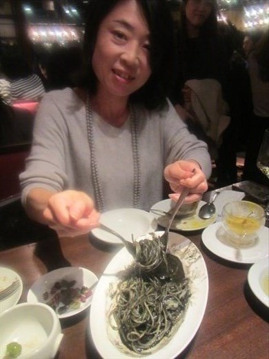 Narumi dishing out the squid ink pasta