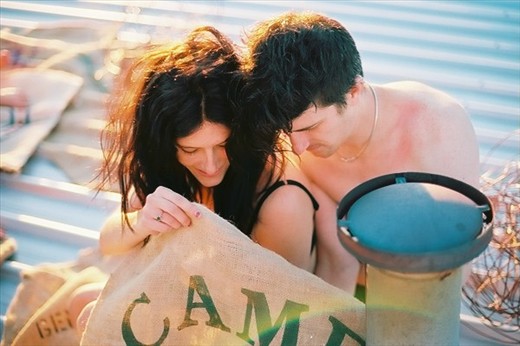 my brother and his girlfriend shielding there flame from the wind. 