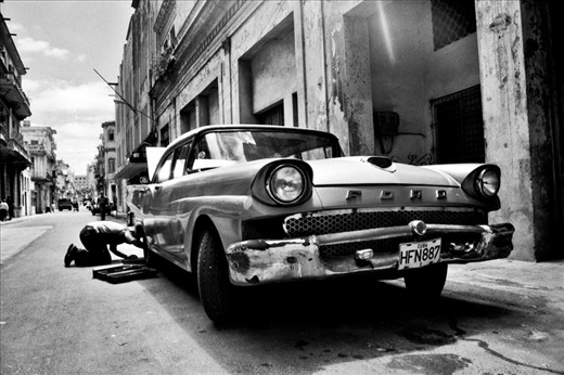 Man repair his  old car in the street of Havana