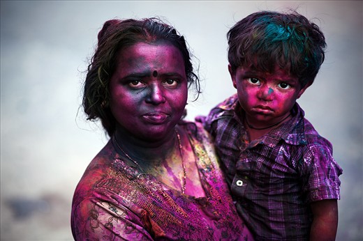 Holi is a flamboyant festival where coloured powder or watercolours are thrown on one another in celebration of the beginning of spring. 
Featured here is a mother and her child after hours of having been doused in the colour. 