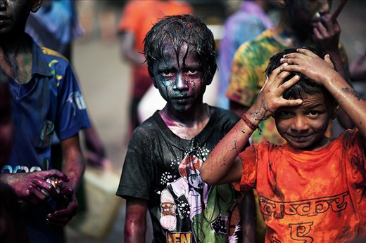 I woke on the morning of Holi to the sound of drums which I believed belonged to a large band perhaps playing to a local community. 
I dressed hurriedly grabbed my camera, and  ventured towards the sound. Upon reaching my destination I was astonished to find that the sound did 
not belong to a parade but a group of boisterous boys hammering on bottles, jars, tins and whatever they could get a hold of blissfully creating havoc with their make-shift percussion.
Holi is an incredibly exciting day for children, who wake in the early hours of the morning to participate in the fun-filled proceedings.