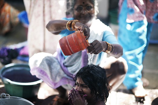 It can take days to rid yourself of the lingering stain the colours thrown leave on your skin during Holi. Here a child is regretfully being washed of the colour by an auntie.