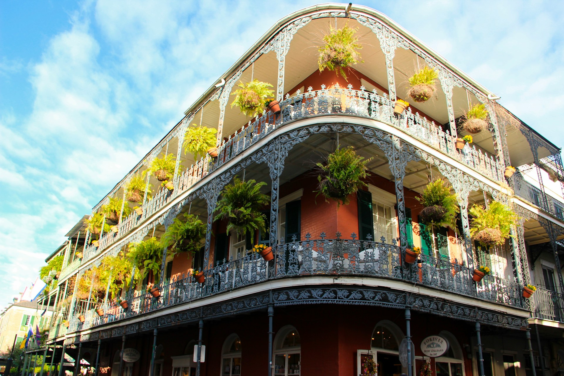A building in New Orleans with plants on the balcony