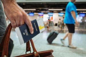 someone holding bag and american passport in airport