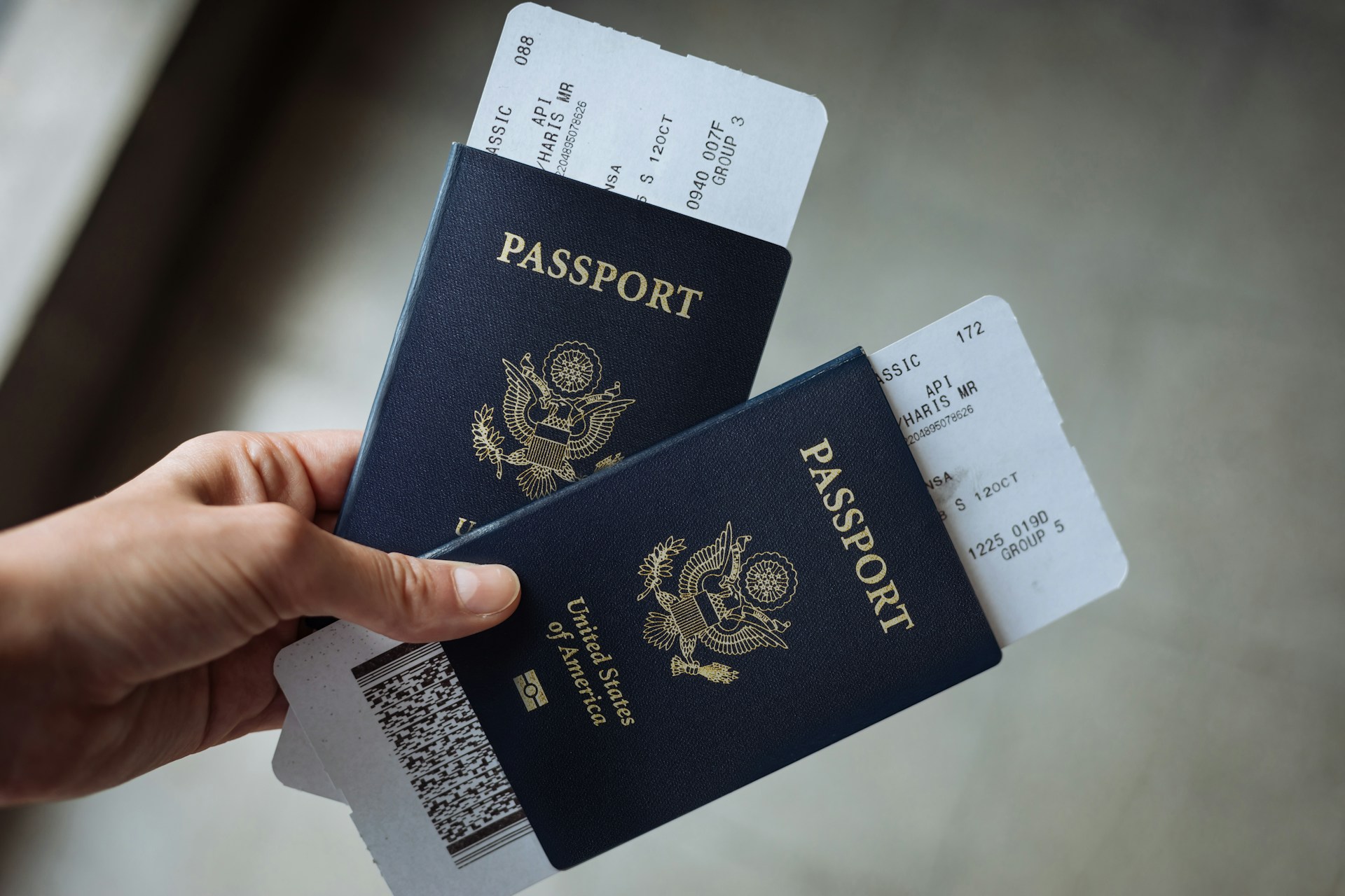 Two US passports with boarding passes tucked inside