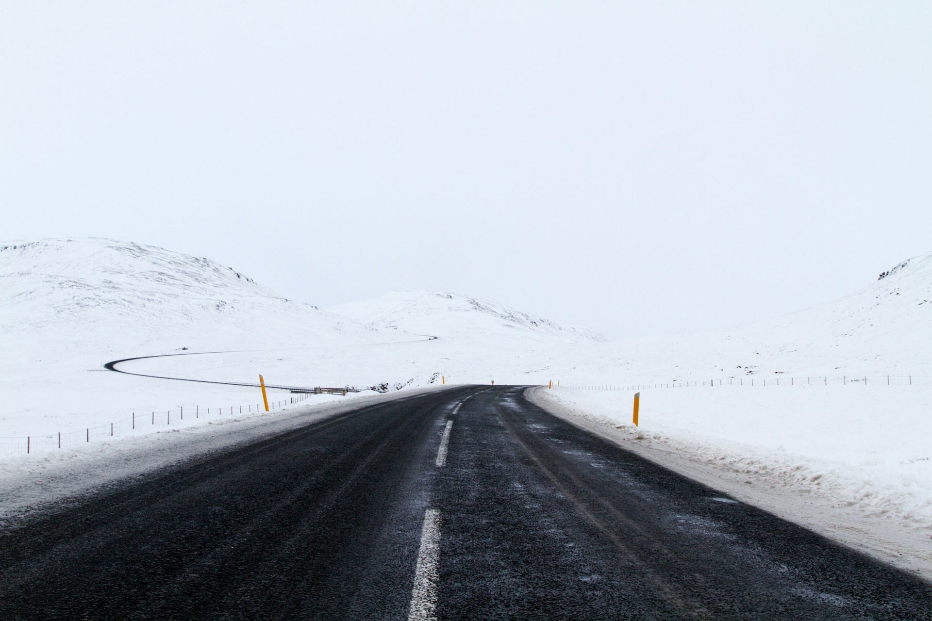A winter road, with thick snow on either side
