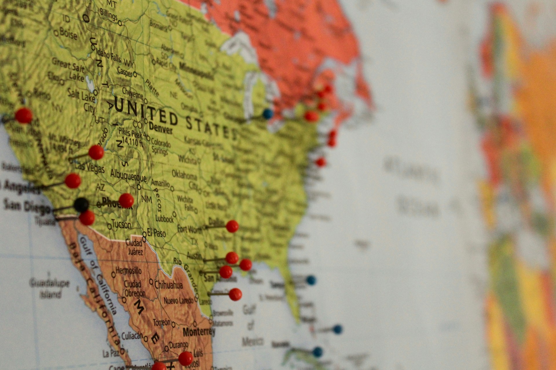 A map of the United States. States to travel to are marked with pins