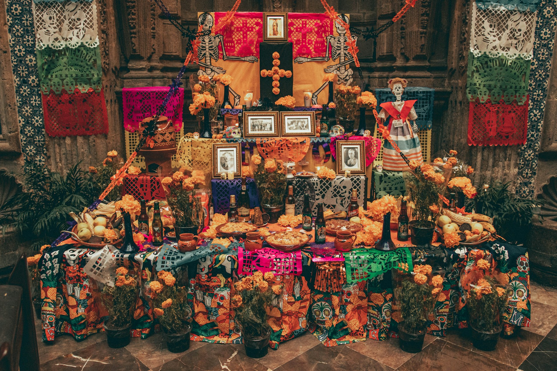 An ofrenda decorated with family photos and marigolds