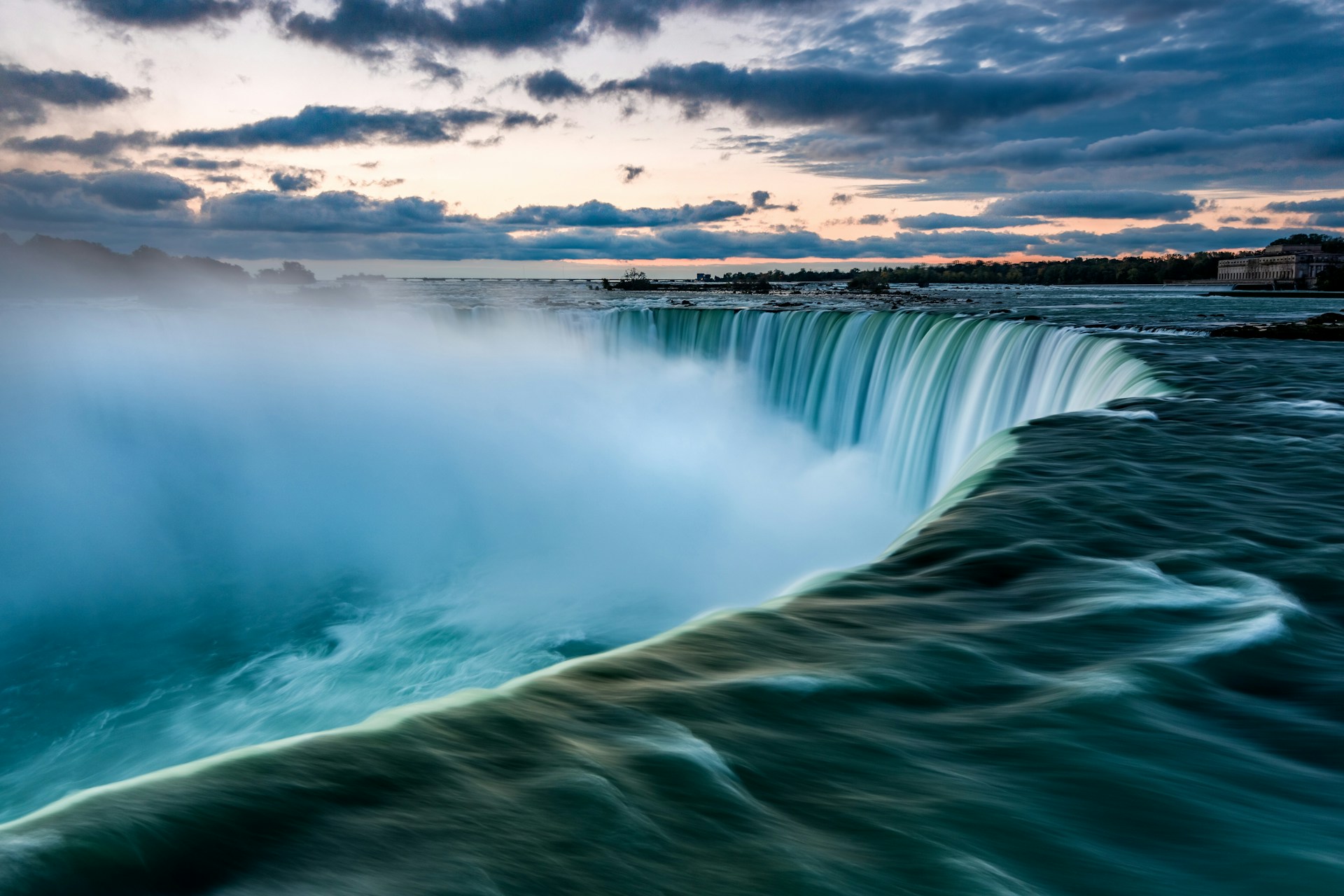 large river with water cascading over the edge