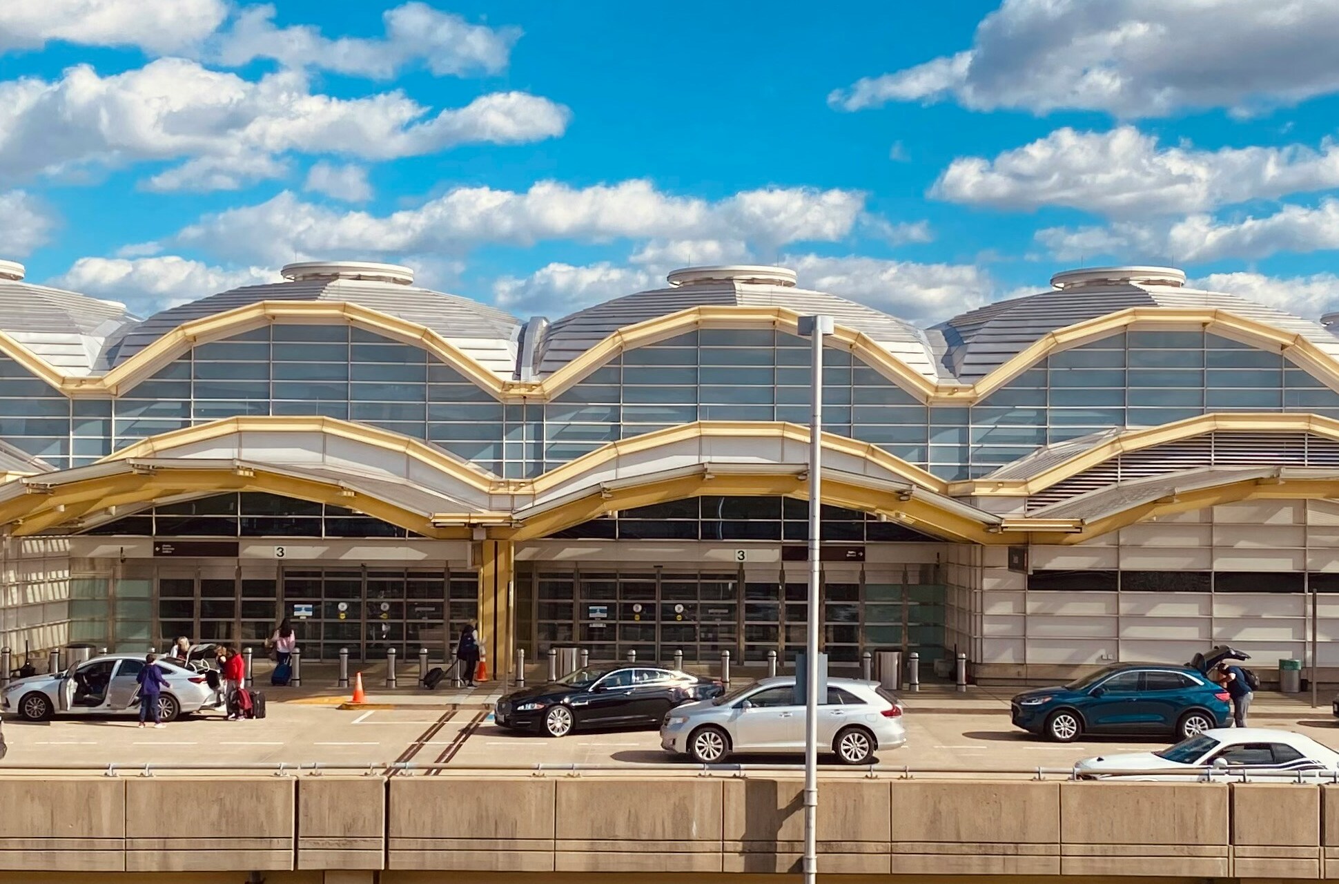 building with arched roof and cars parked in front