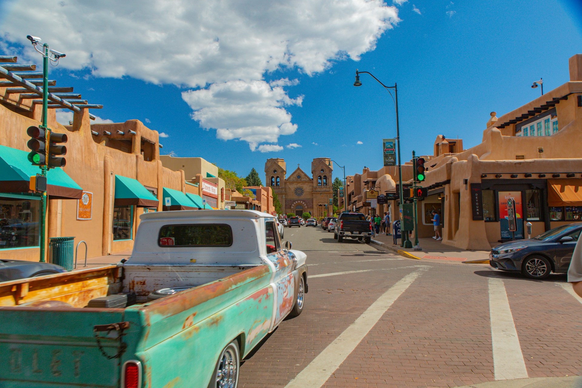 A rusting truck facing a bright street in Santa Fe