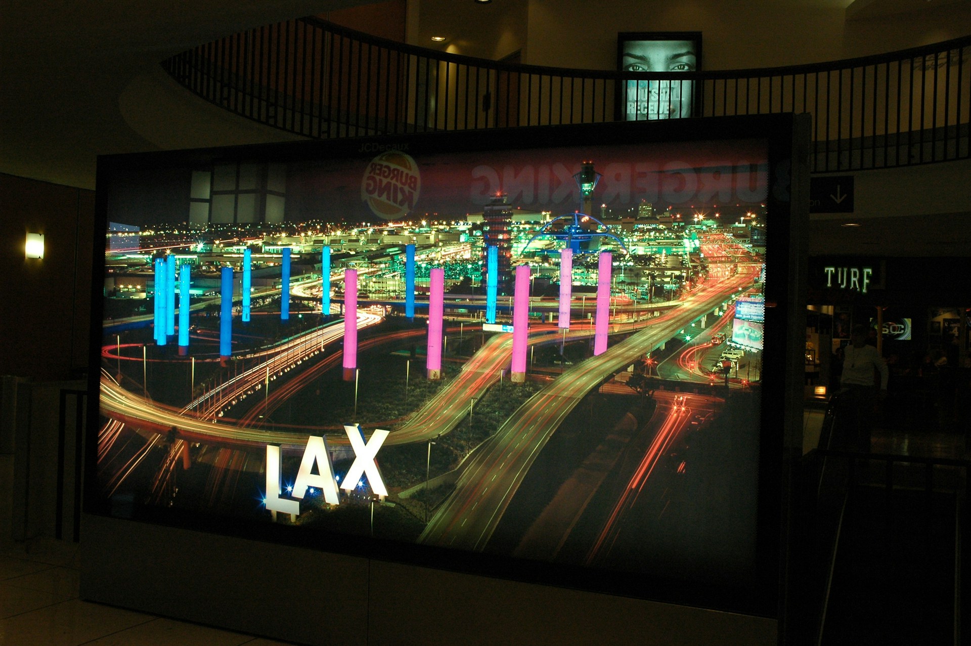 reflection of LAX sign at the International Airport, with columns of pink and blue