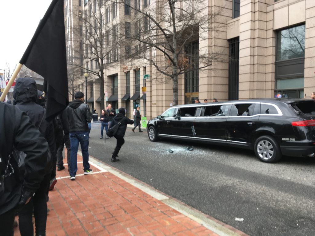 A limousine with its windows smashed in downtown Washington. (Tara Bahrampour/The Washington Post)