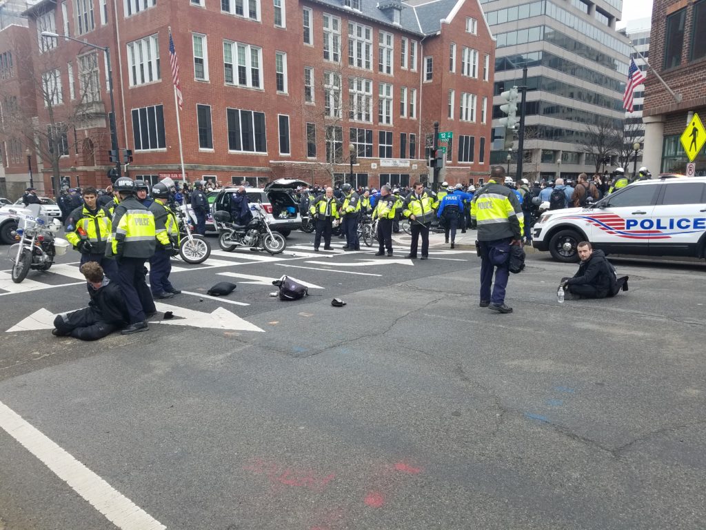 Two men being taken into custody at 12th and L St. NW during protests the morning of inauguration. (Clarence Williams/The Washington Post)