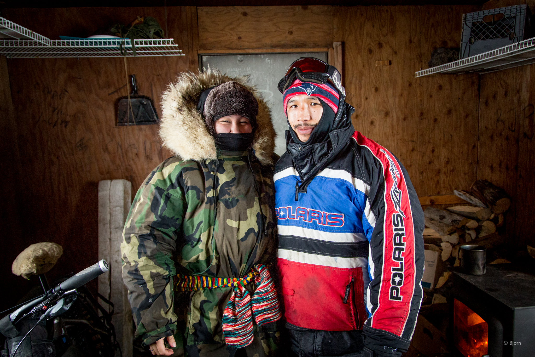 Buckland residents, Glenn and Viola Thomas, come inside the Gallahan shelter and out of the blizzard, on their snowmachine trip to Kotzebue. Glenn and Viola eventually decided to remain in the shelter with Bjørn Olson and Kim McNett, who were sitting out the storm on their fat-bike trip from Nome to Kivalina in March 2016. (Bjørn Olson)