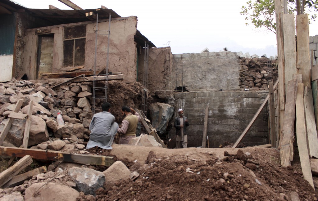Pobladores en la región controlada por Pakistán reconstruyen una casa golpeada por los enfrentamientos (AP)