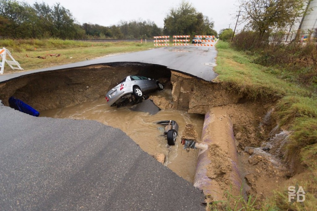 A deadly sinkhole in an industrial part of San Antonio swallowed two cars Sunday evening (San Antonio Fire Department)