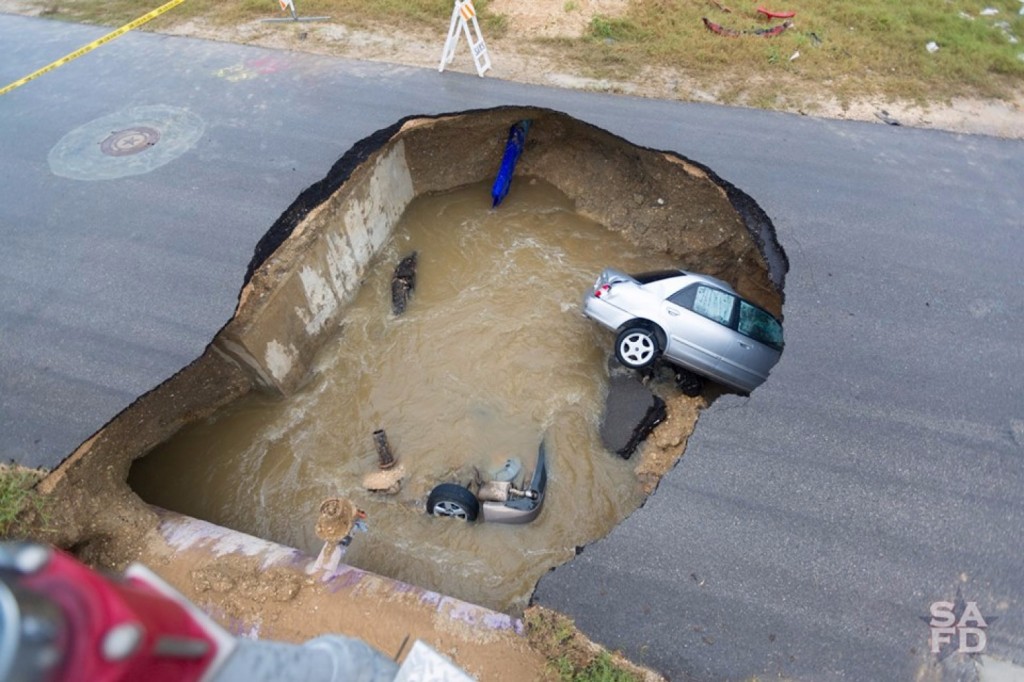 A deadly sinkhole in an industrial part of San Antonio swallowed two cars Sunday evening (San Antonio Fire Department)