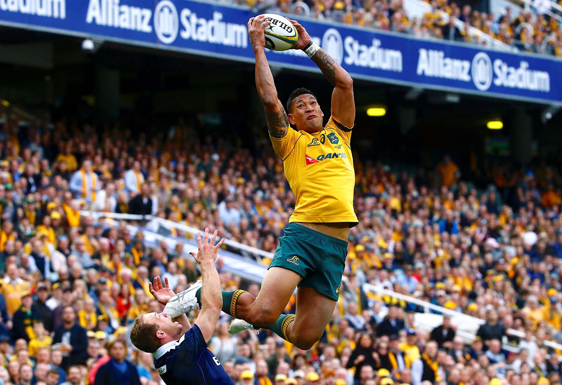 El australiano Israel Folau salta por encima del escocés Greig Tonks para tomarr el balón y marcar un try en Sydney