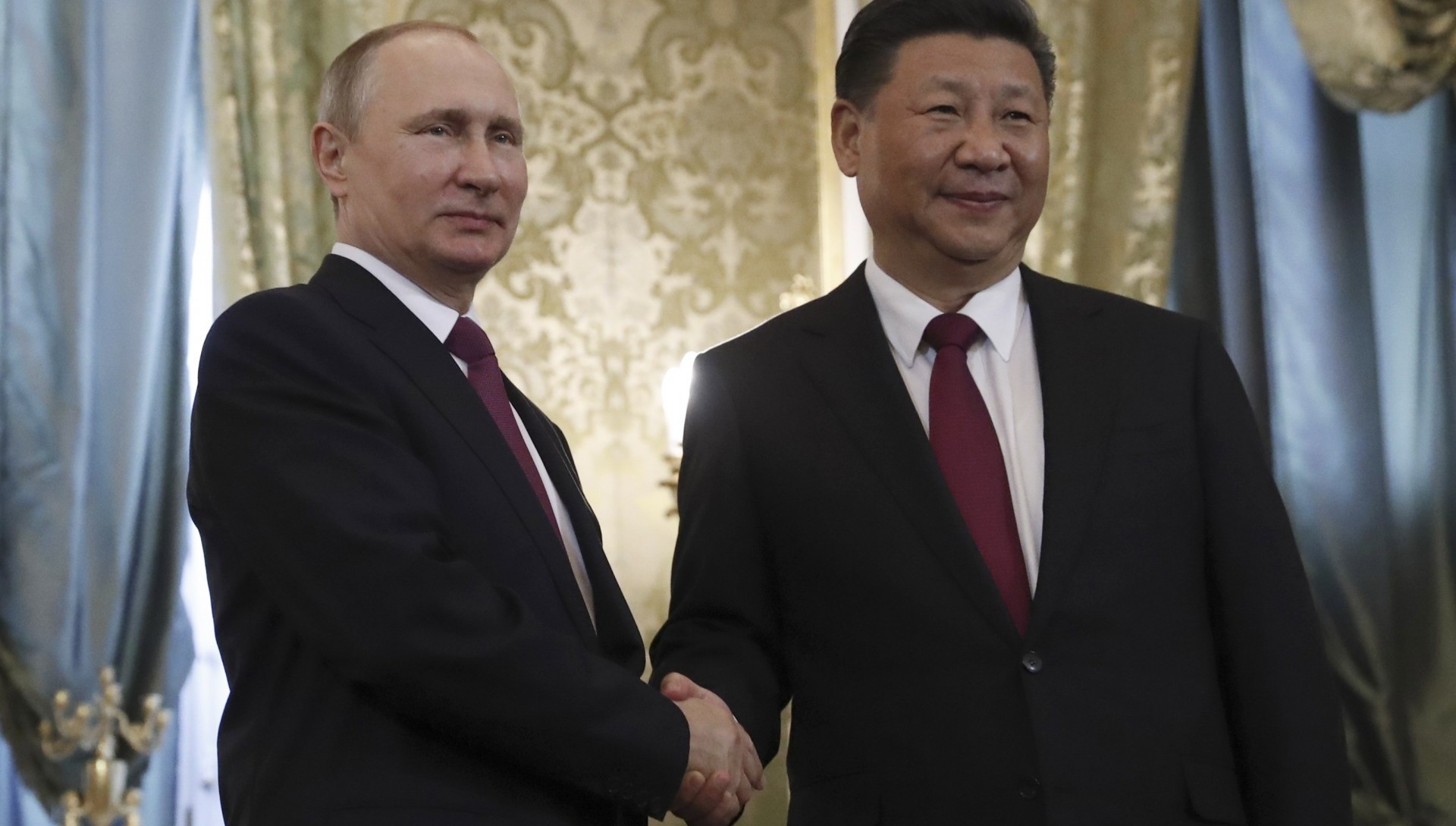 Vladimir Putin saluda a Xi Jinping durante una visita oficial en el Kremlin (REUTERS/Sergei Ilnitsky/Pool)
