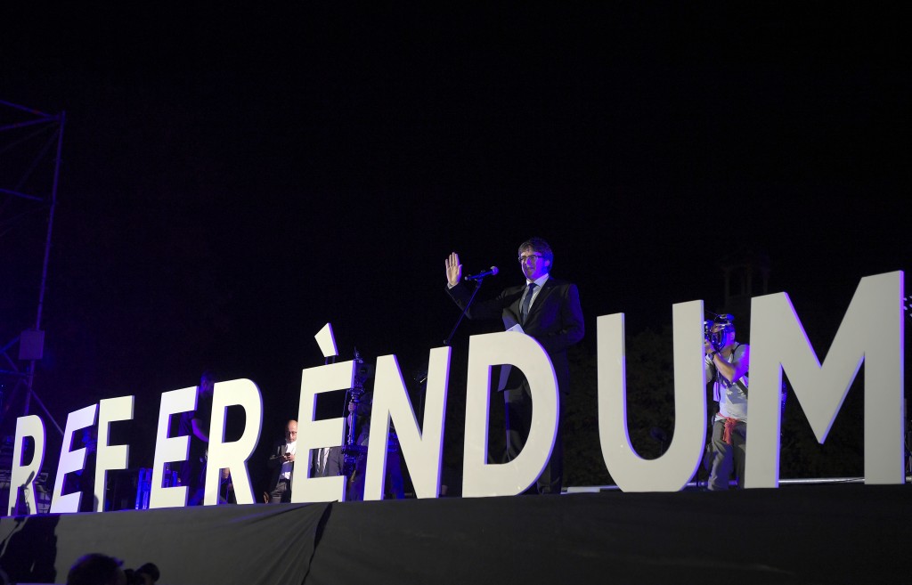 Catalan president Carles Puigdemont speaks during the closing meeting of the Catalan pro-independence groups and political parties that campaign for 'Yes' in the upcoming October 1 referendum on self-determination in Catalonia, in Barcelona on September 29, 2017. With two days left until an independence referendum in Catalonia opposed by Madrid, Catalan leaders say they have over 2,000 polling stations ready despite a crackdown on their preparations for the vote as authorities in Madrid have instructed police to ensure no votes are cast in October 1 vote as they tackle one of the biggest political crises to hit Spain since democracy was restored in the 1970s following the death of longtime dictator Francisco Franco. / AFP PHOTO / LLUIS GENE