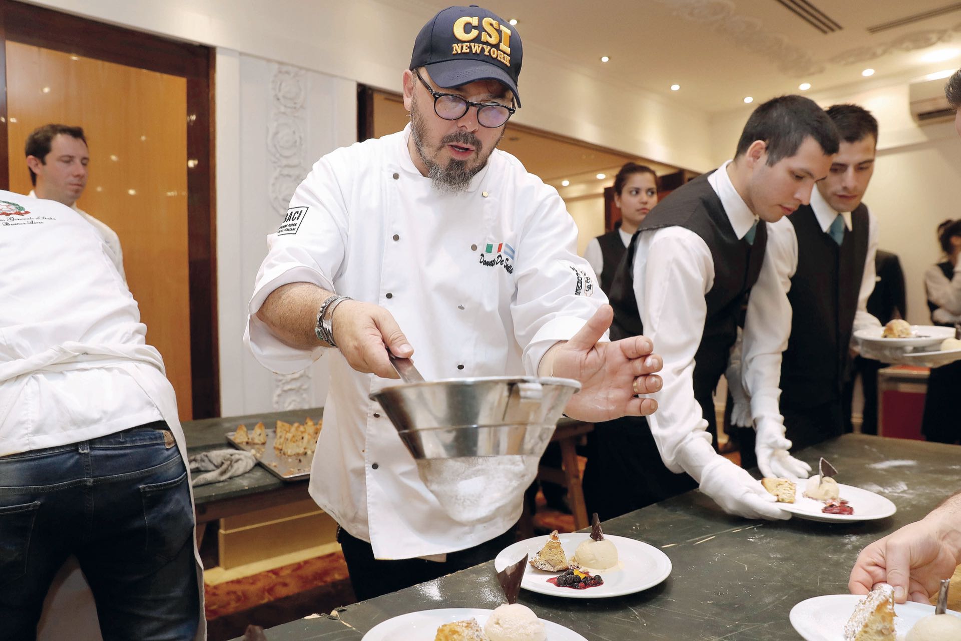 Donato espolvorea la pasticceria, que llegará después de la cena. Foto: francisco Trombetta/GENTE