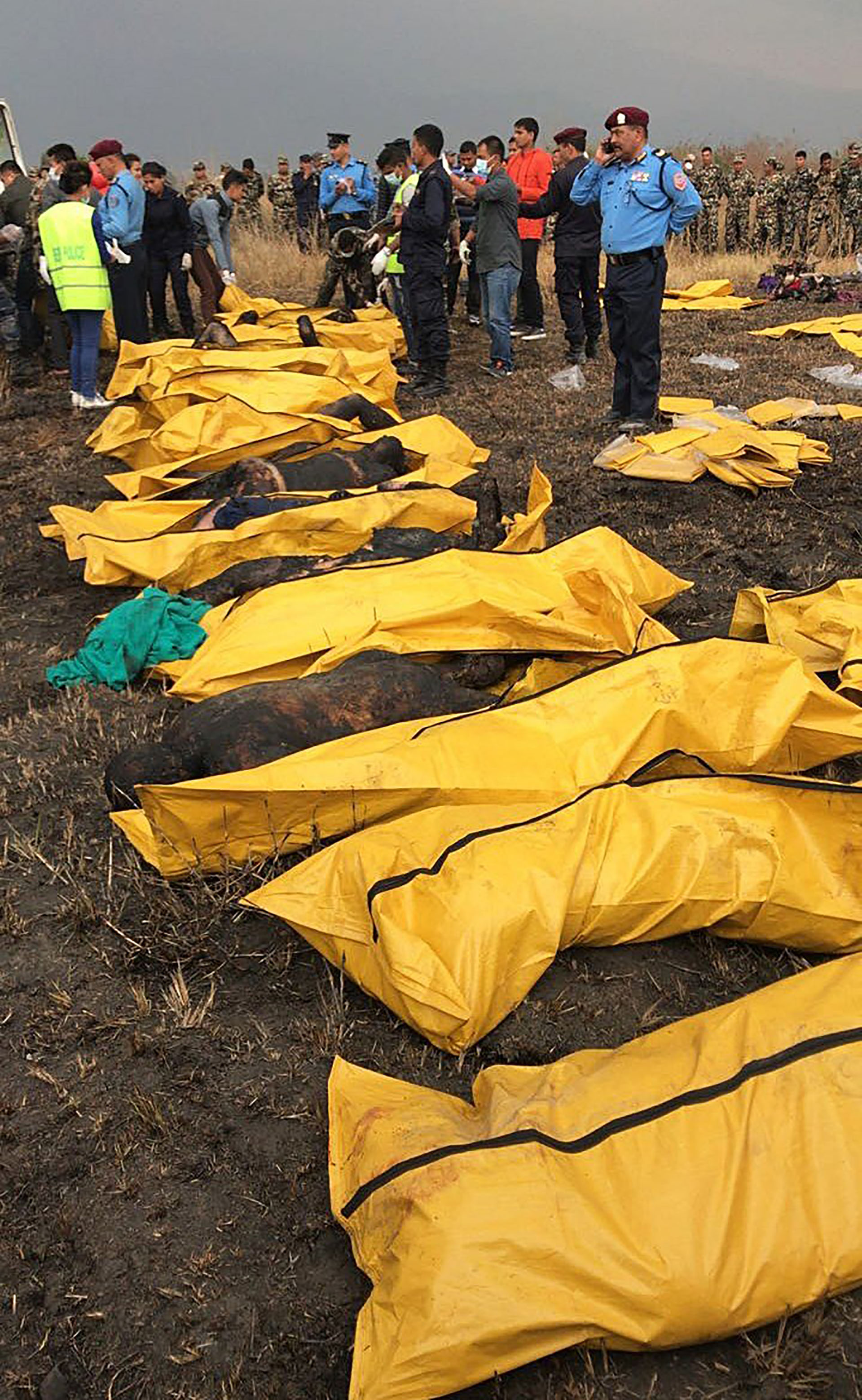 Los cadáveres calcinados de varias víctimas tras ser recuperados por los equipos de rescate de entre los restos del avión que se estrelló en el aeropuerto de Katmandú