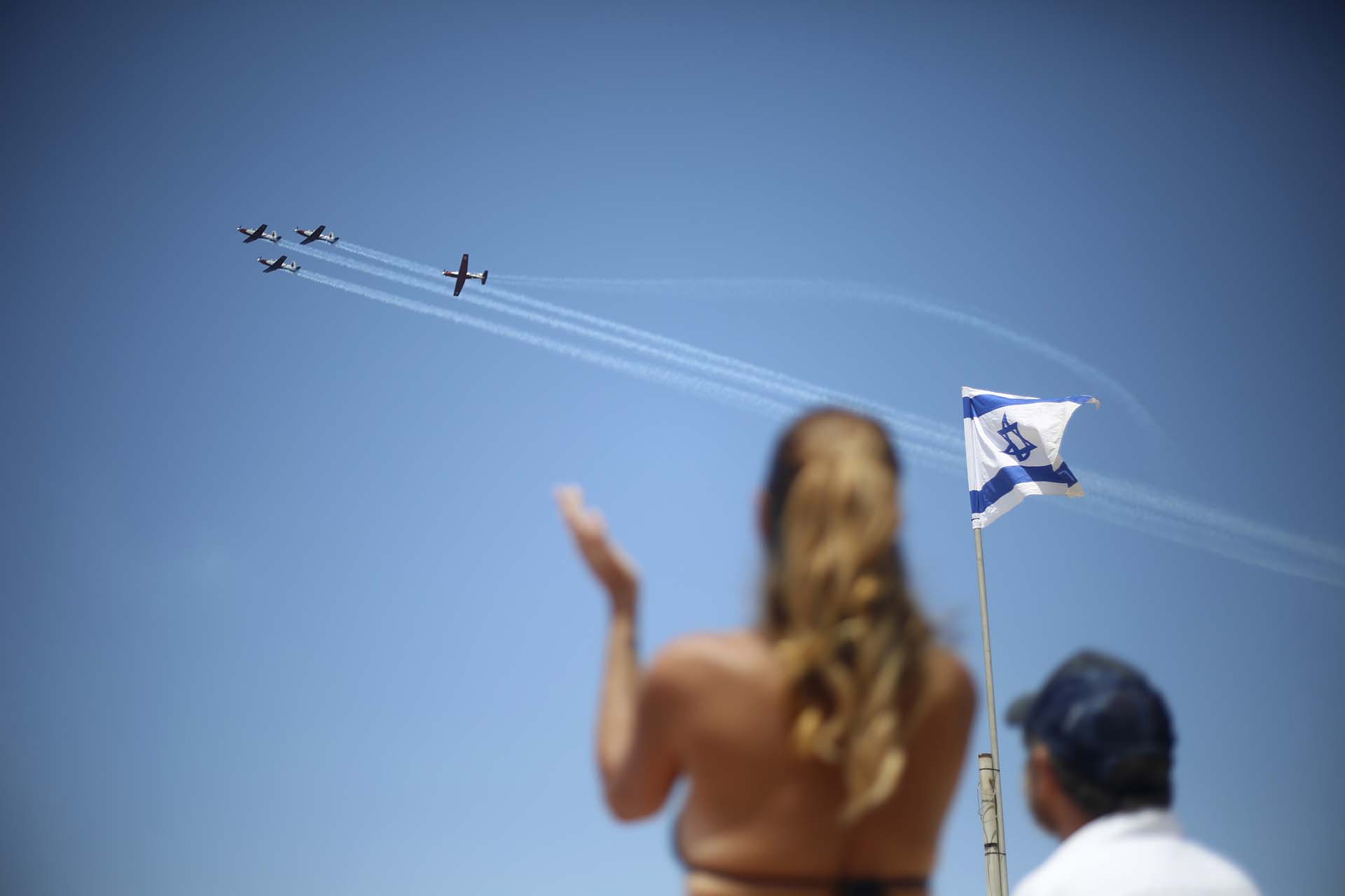 Dos israelíes observan el show aéreo en Tel Aviv, con motivo del 70 aniversario de la independencia (AP Photo/Ariel Schalit)