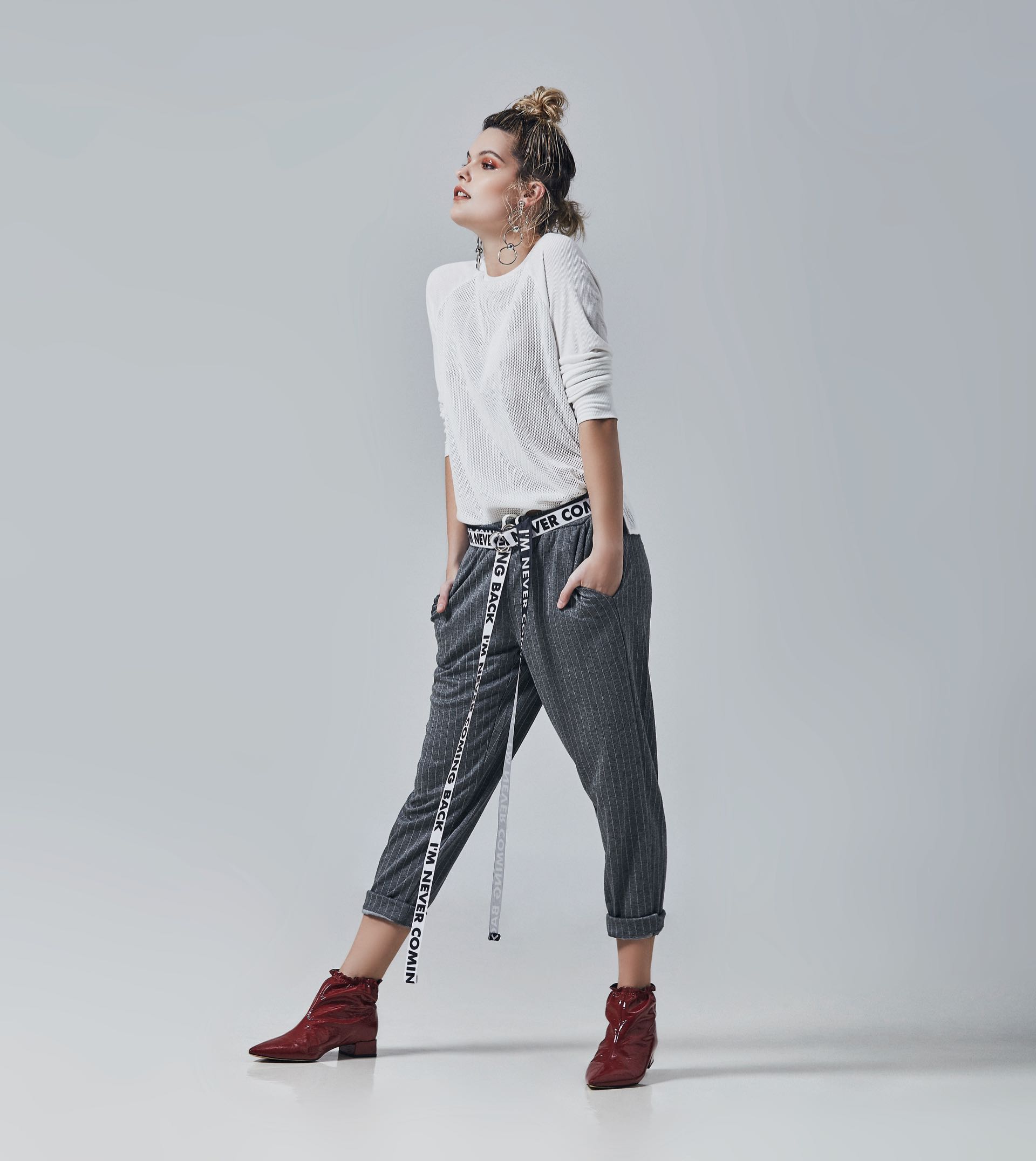 Remera de red ($ 1.150, Ríe), pantalón deportivo con rayas finitas ($ 1.918, La Cofradía), botinetas charoladas ($ 3.390, Blaquè), aros y cinto estampados ($ 250 y $ 150, Paw Accesorios).
