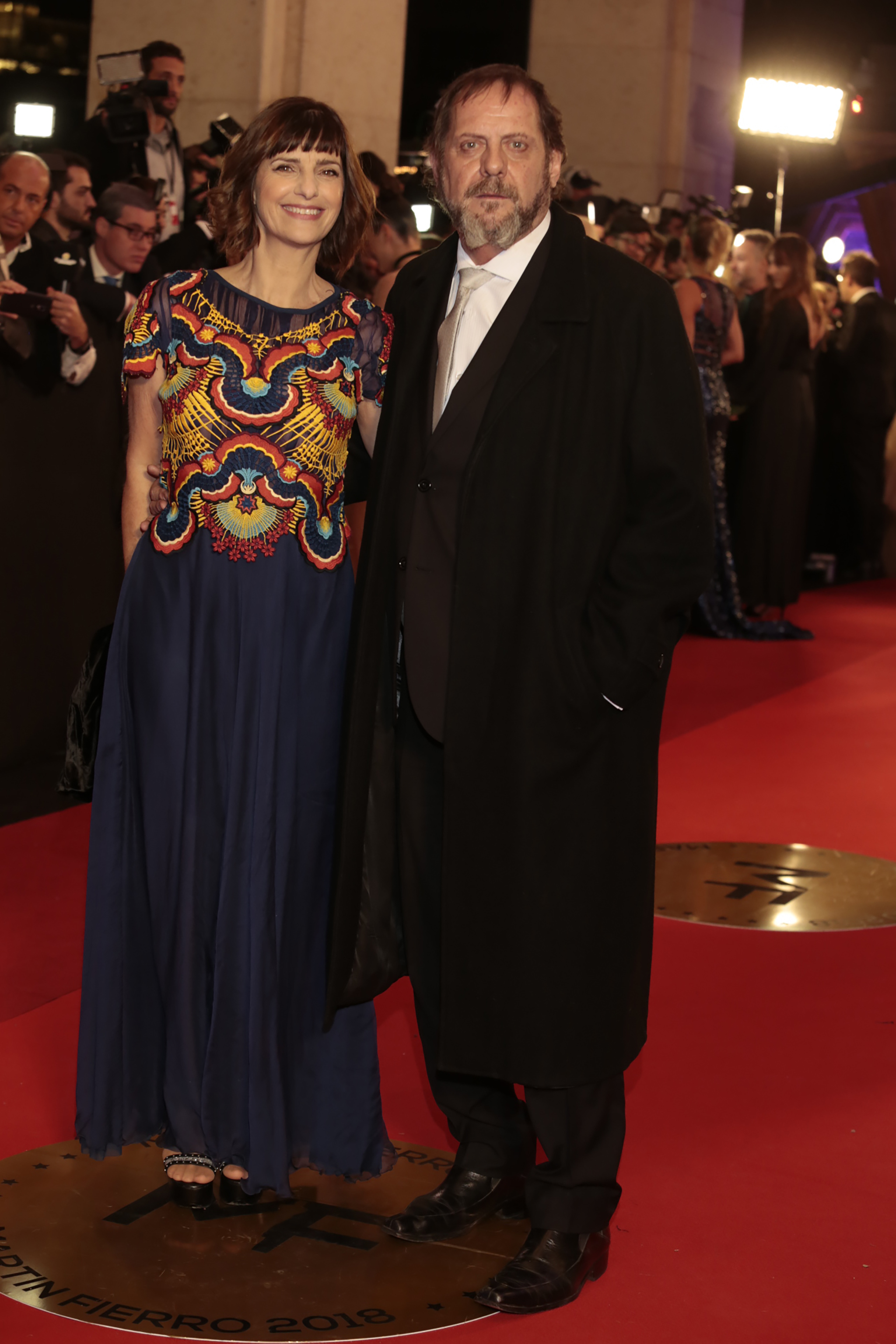 Los actores Silvia Kutika y Luis Luque, ganador como actor de reparto en “Un gallo para Esculapio”. Ella, con diseño de Benito Fernández y él, un traje clásico con corbata plateada y sobretodo negro.