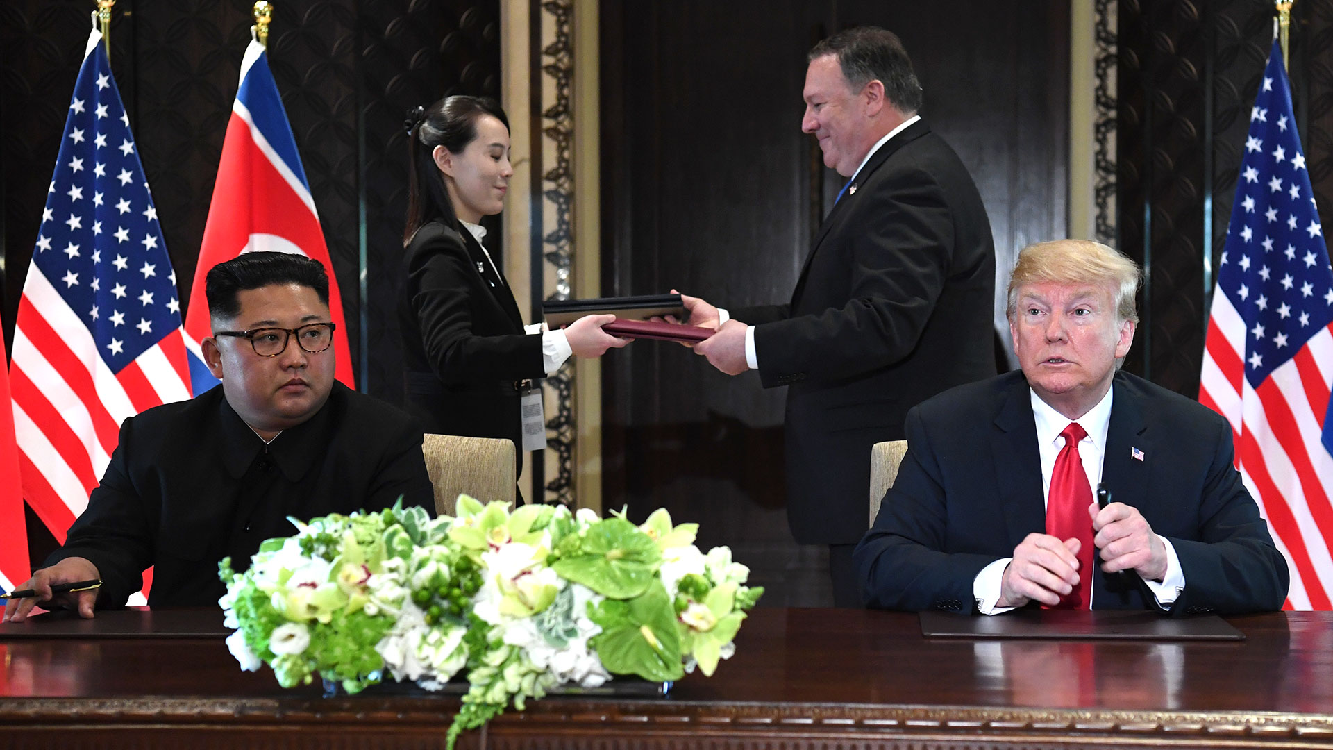 Kim Yo-jong y Mike Pompeo intercambian los documentos firmados. (AFP)