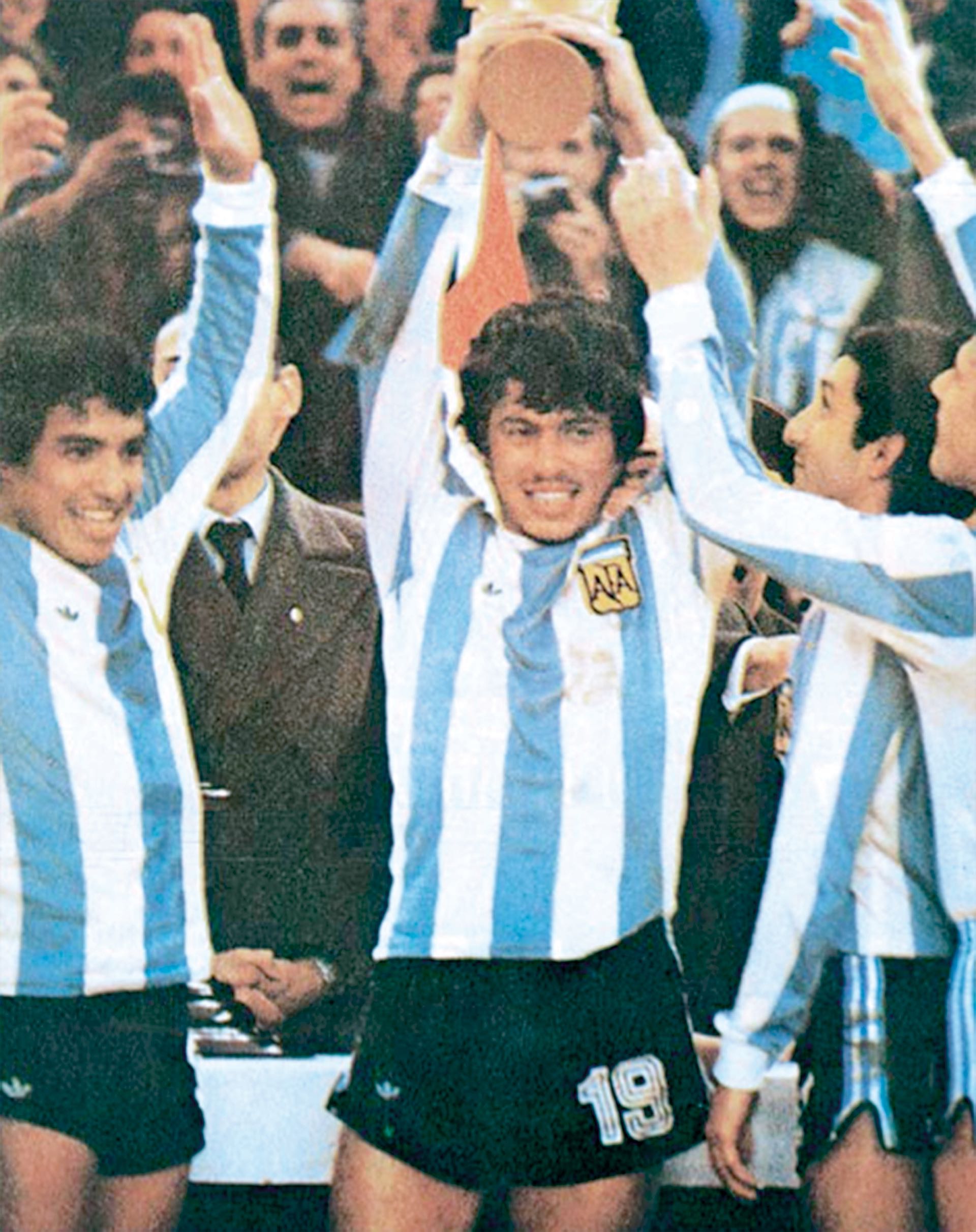 Daniel Alberto Passarella levanta la Copa. Ardiles la mira embelesado, mientras Gallego levanta triunfalmente sus brazos.