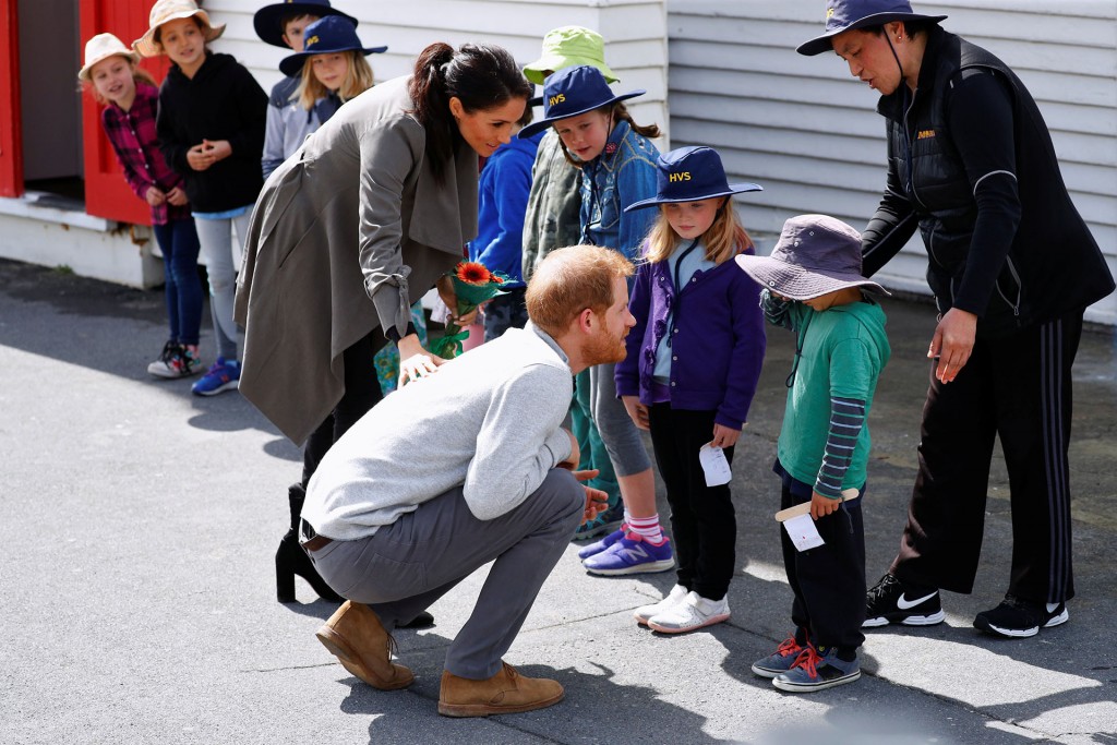 Britain's Prince Harry and Meghan, the Duchess of Sussex talk to Joe Young (in green jumper) as they meet with children outside a cafe, in Wellington, New Zealand October 29, 2018. REUTERS/Phil Noble