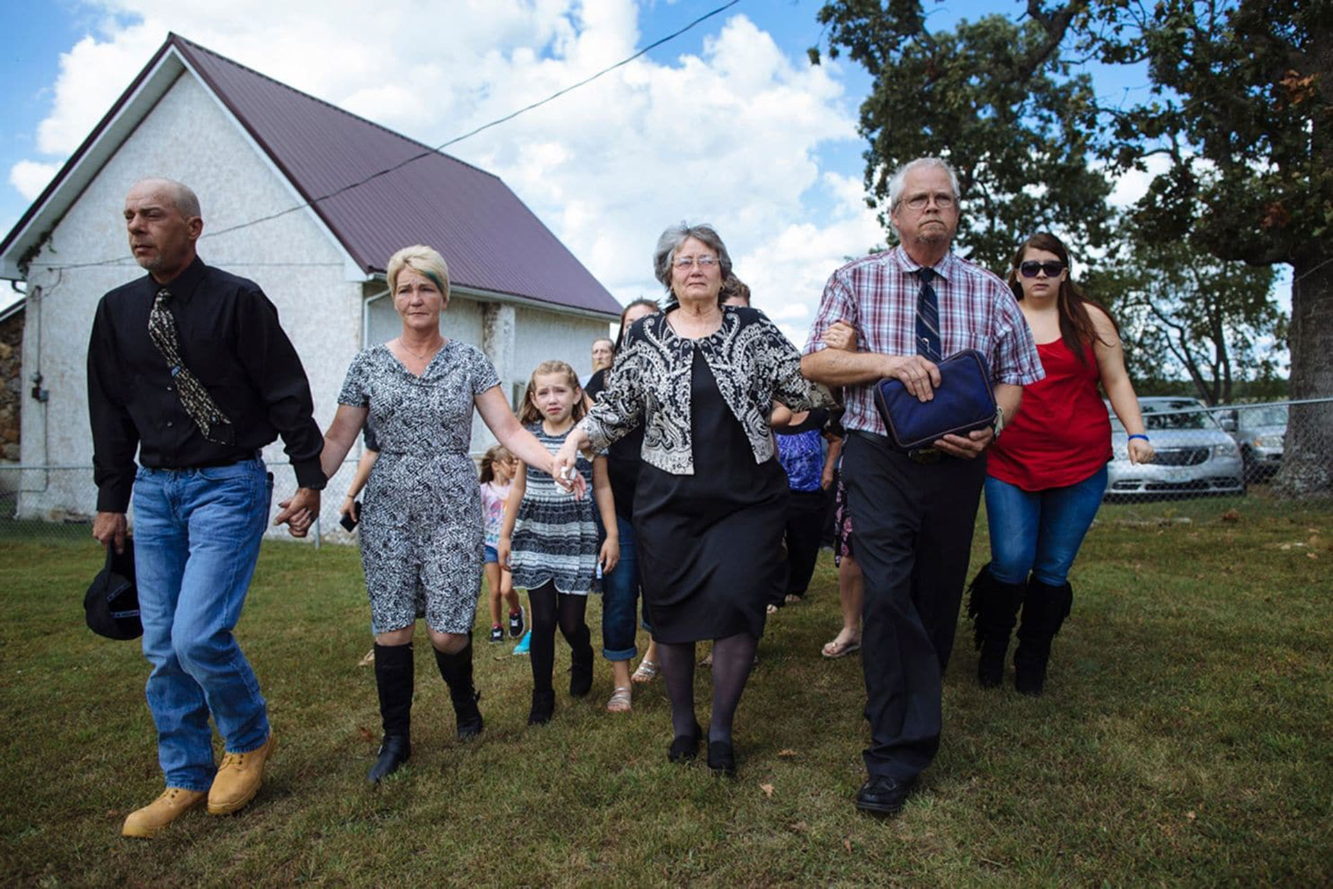 Raeleigh camina en la procesión funeraria detrás de Patsy May y su abuela materna, Elizabeth “Becky” Lamson, de 47 años (Angus Mordant/The Washington Post)