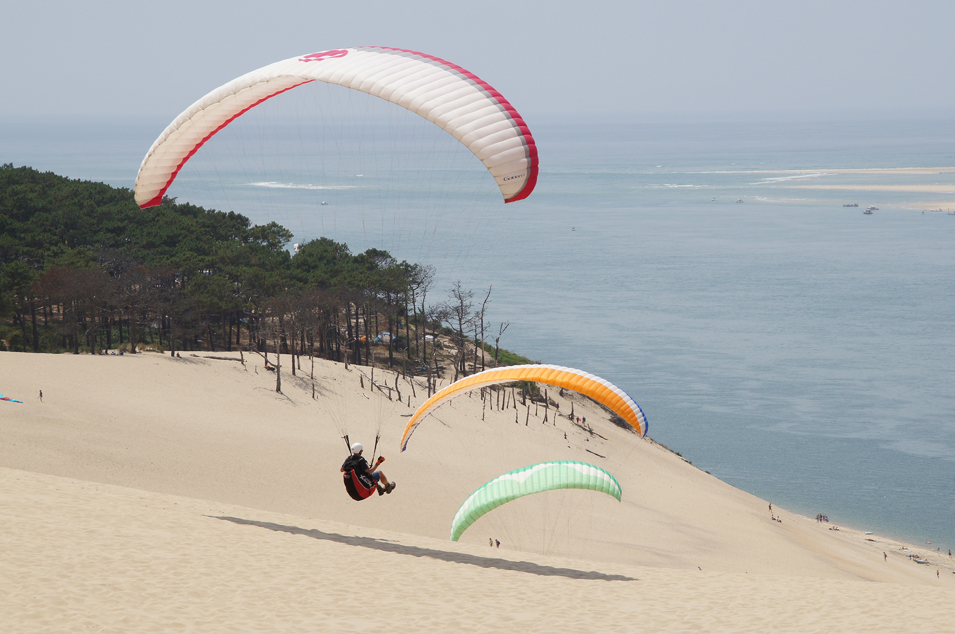 Las enormes dunas de Pyla-sur-Mer, en la costa francesa, no sólo invitan a sus playas, sino a los deportes de aire, como el parapente.