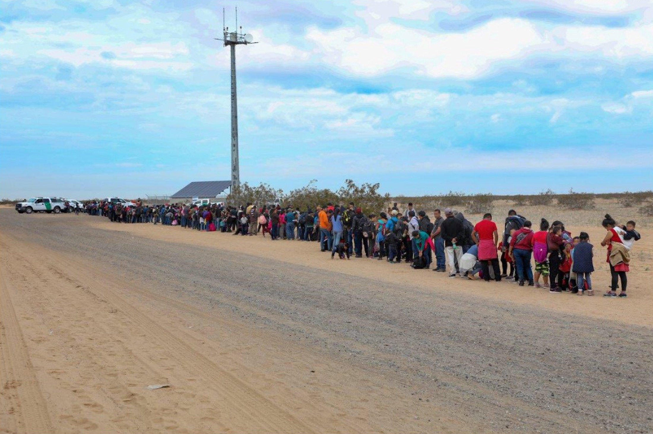 Casi 400 migrantes esperan en fila para ser registrados luego de ser detenidos por la Patrulla Fronteriza (Reuters)