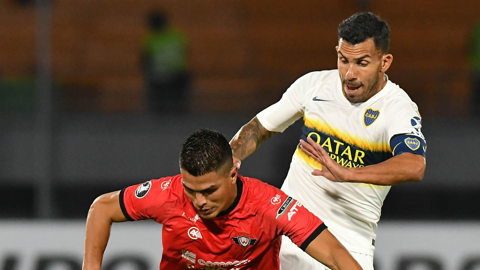 AME3198. COCHABAMBA (BOLIVIA), 05/03/2019.- Juan Aponte (i) de Wilstermann disputa un balón ante Carlos Tévez (i) de Boca Juniors este martes, a lo largo de un partido de la Copa Libertadores, entre el Wilstermann de Bolivia y el Boca Juniors de Argentina, en el estadio Félix Capriles de Cochabamba (Bolivia). EFE/ Jorge Abrego