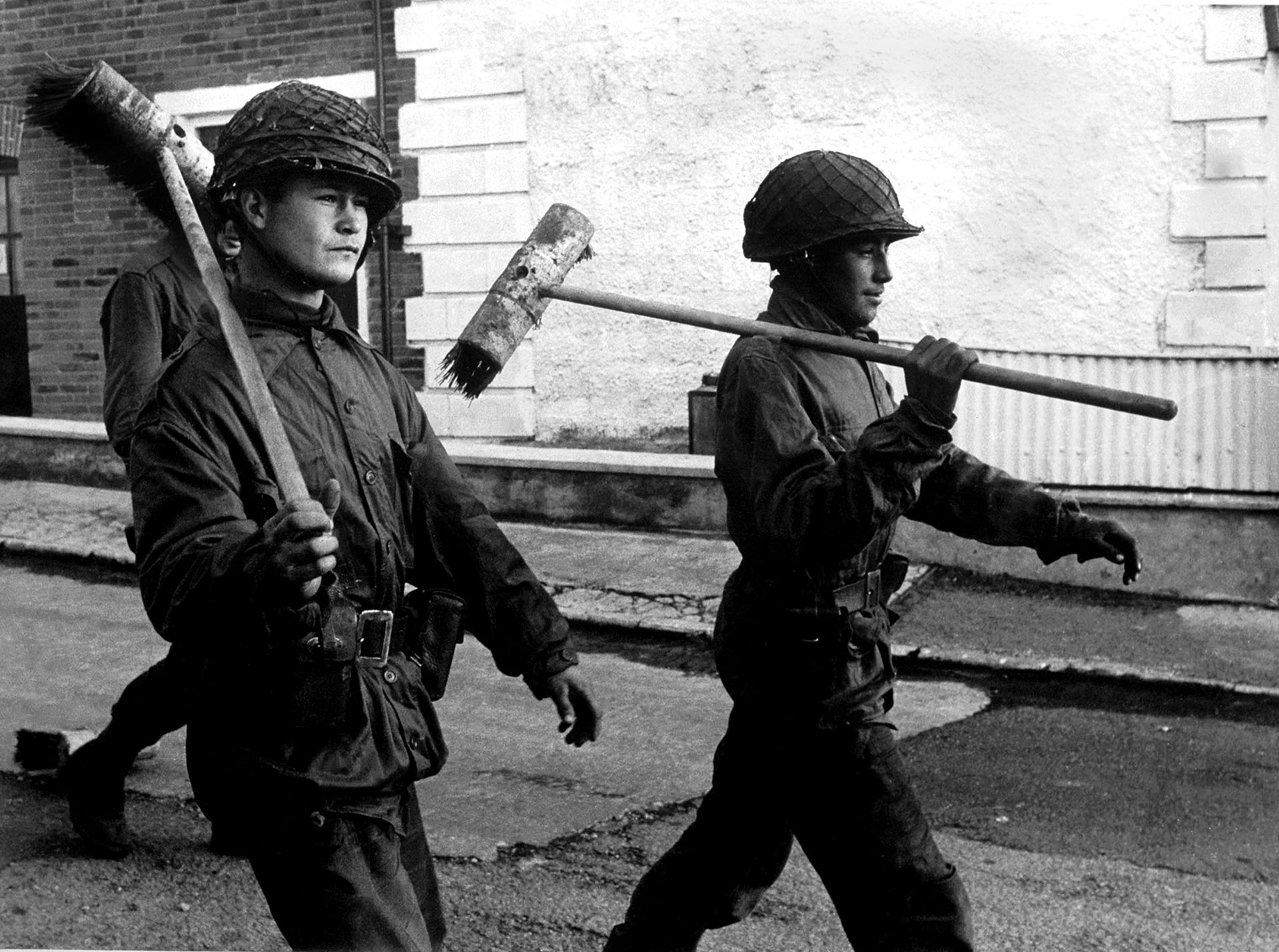 Si bien son soldados que acaban de realizar una tarea de acción cívica, como mantener limpias las calles, para Eduardo Farré, el fotógrafo que captó la imagen, la cuestión pasa por otro lado: “Es mi mirada sobre cualquier guerra. Los vi marchando con los escobillones al hombro como si fueran armas y me llamó la atención ese contraste con lo que se estaba viviendo”.