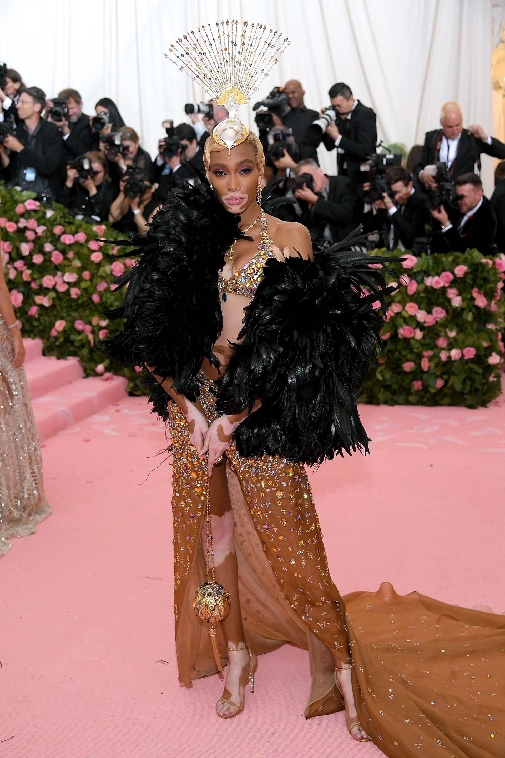 La supermodelo Winnie Harlow lució una chaqueta de plumas negra, una falda y corpiño de strass y una extravagante corona