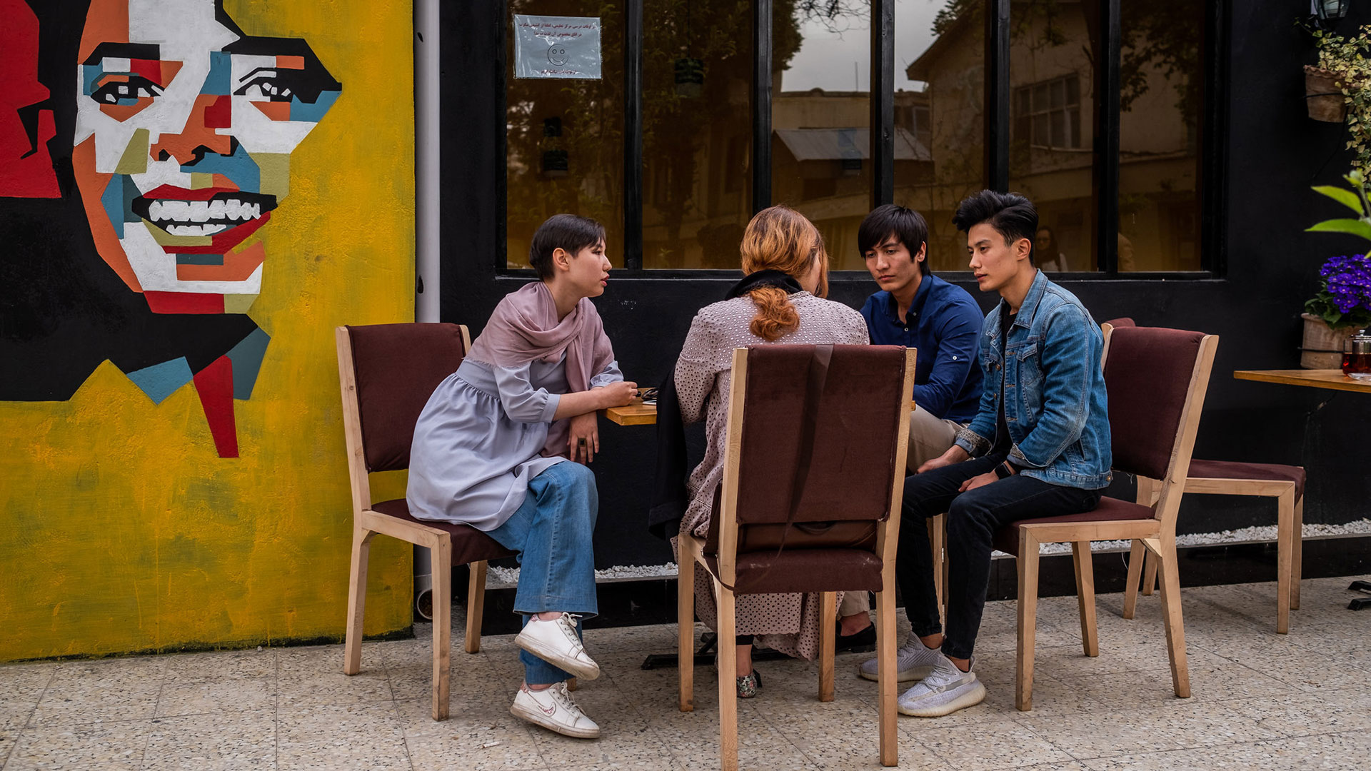 Hadis Lessani Delijam, a la izquierda, en una reunión con amigos en la cafetería Jackson en Kabul, Afganistán (Jim Huylebroek/The New York Times)