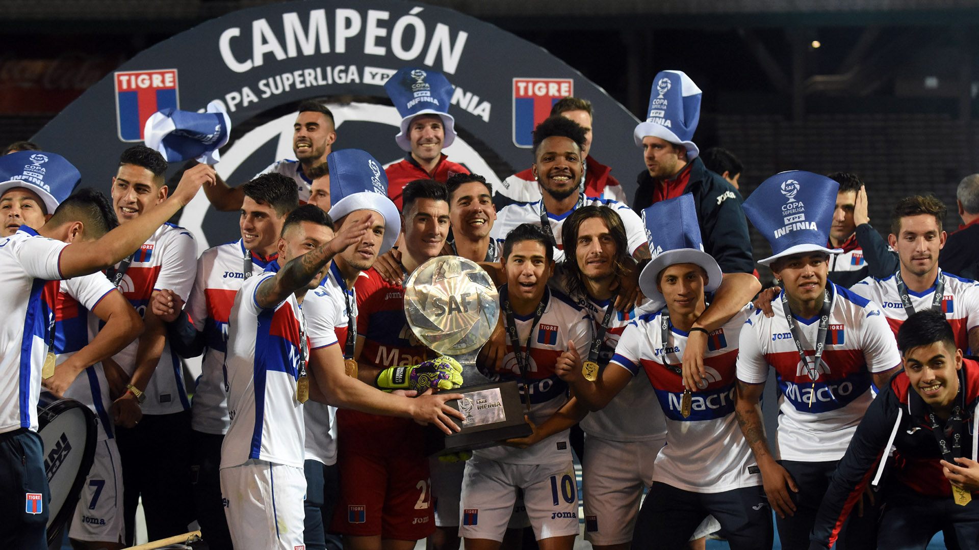 Los futbolistas celebran con el trofeo