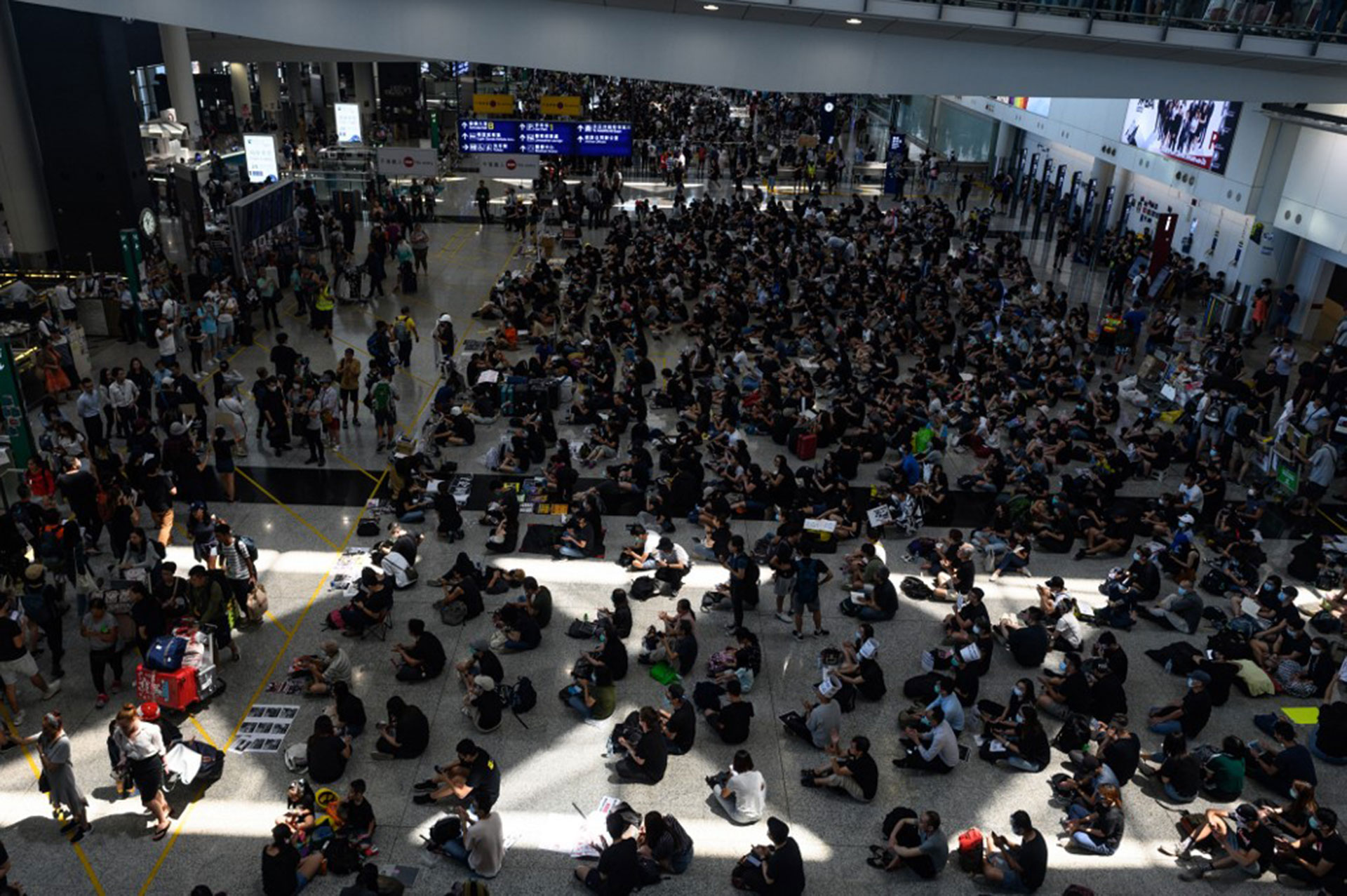 Cientos de manifestantes a favor de la democracia, en un un nuevo mitin en el aeropuerto de Hong Kong (Foto de Philip FONG / AFP)