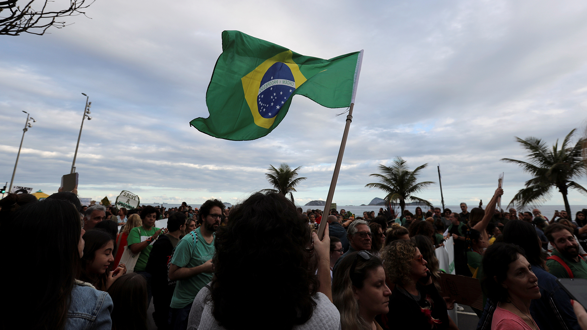 Un asistente sostiene una bandera brasileña durante la manifestación para exigir más protección para la selva amazónica. REUTERS / Sergio Moraes