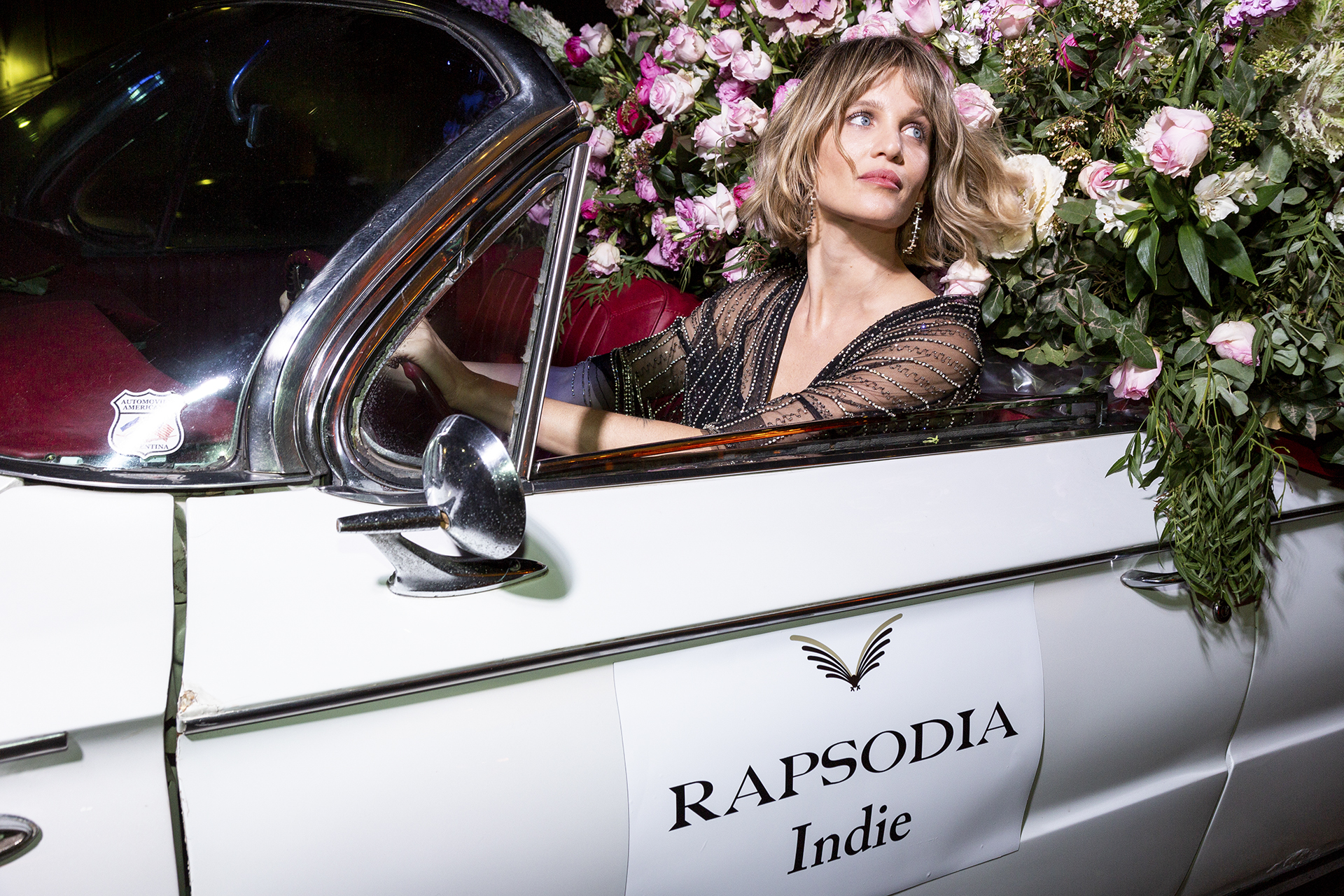 Liz Solari rodeada de flores en el auto de Rapsodia Indie