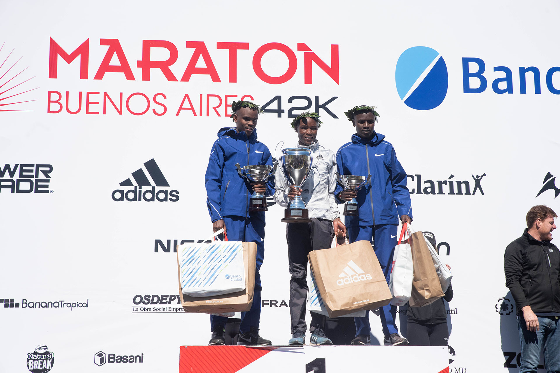 Los tres integrantes del podio, con sus trofeos y regalos en las manos