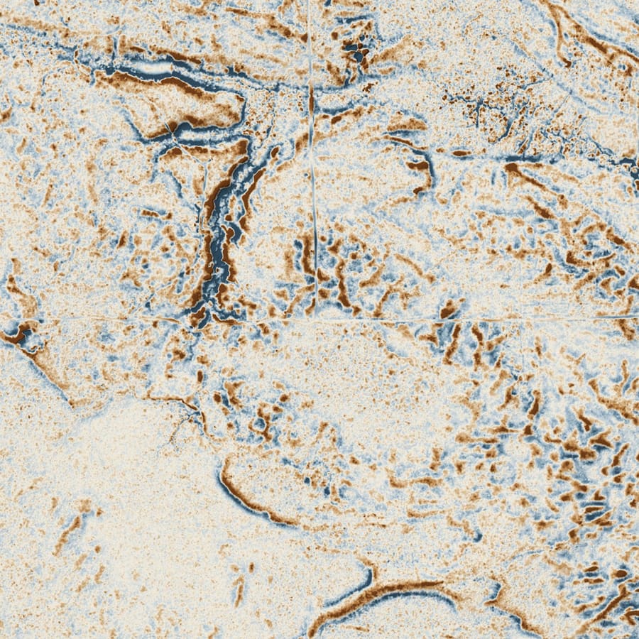 Relief plate of King's Highway at Hannigan's Road: a shaded local-relief model of a frame 1,400 m across, drawn from bare-earth LiDAR. Cuts below the local mean are blue, fills above it brown.