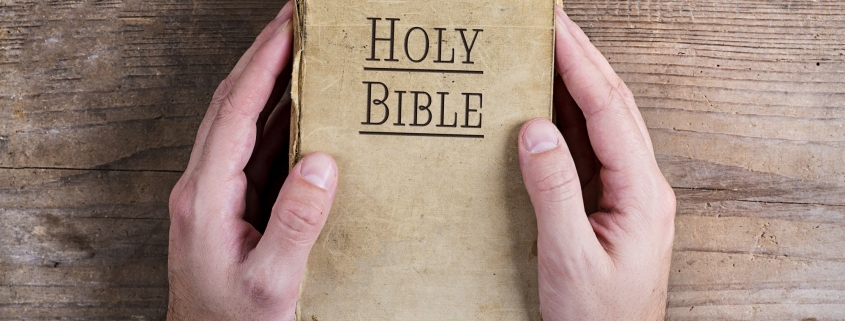 Bible and praying hands