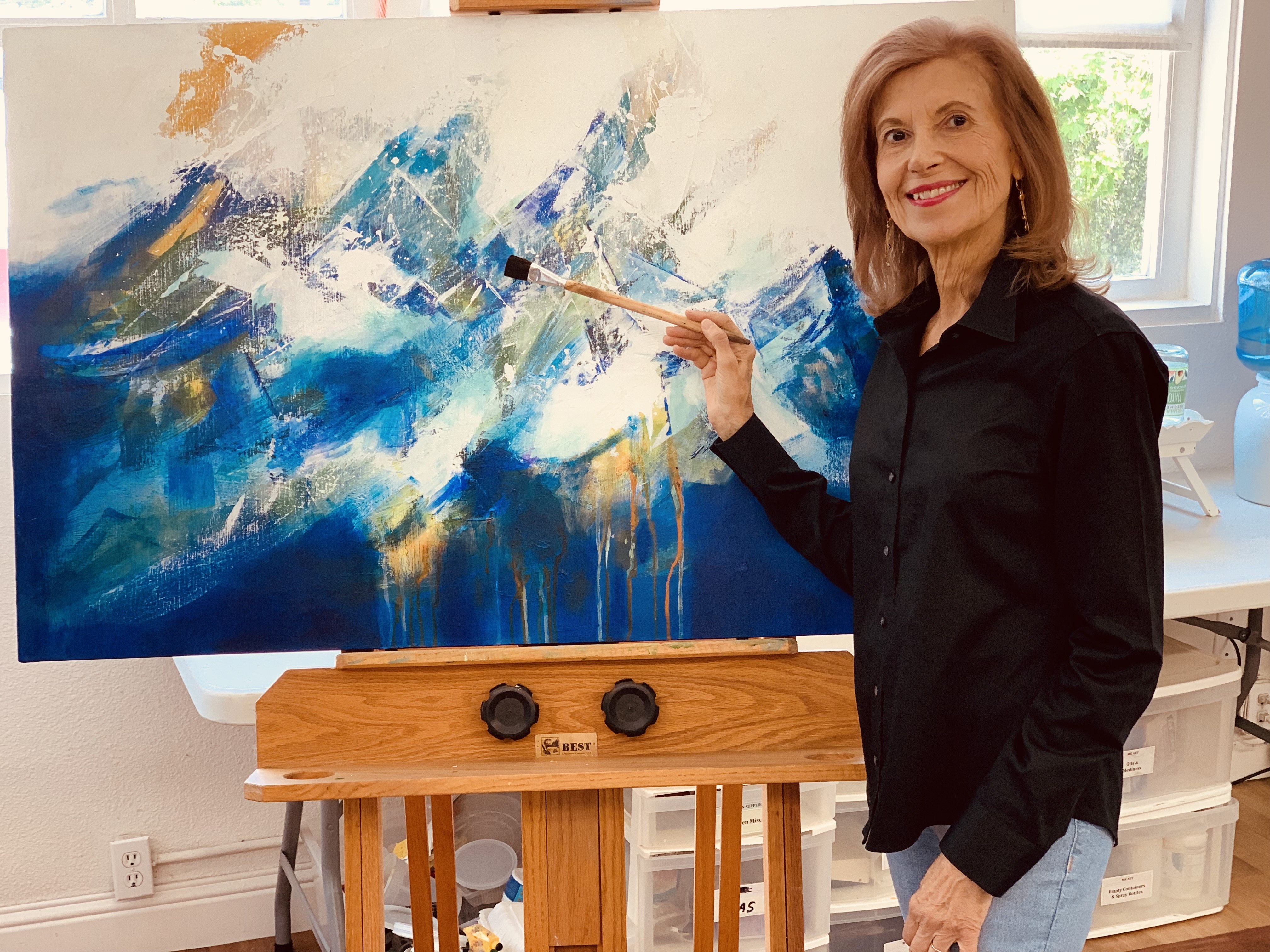 Mary Karlton with her painting 'On the Verge I'